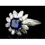 A modern silvery coloured metal mounted sapphire and diamond flowerhead pattern ring, the central