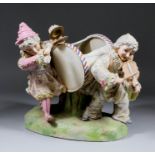 A late 19th Century Continental porcelain group modelled as two children playing instruments, with a