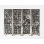 Four Chinese silvery metal miniature screen panels, each cast in relief with various trees and