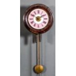 A stained wood cased postman's alarum wall clock, the 7ins diameter pink and white enamel dial