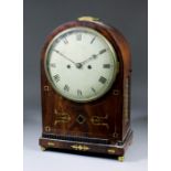 A late George III mahogany cased mantel clock, the 8ins diameter painted domed metal dial with Roman