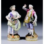A pair of late 19th Century Meissen porcelain figures modelled as a pair of companions in 18th