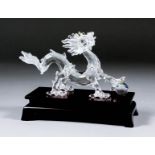 A Swarovski "Crystal Zodiacs" dragon with wooden base, 3.25ins high x 6.75ins long, with original