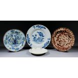 Four 18th Century English pottery plates, comprising - Delft painted in colours with fence and