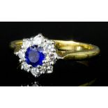 A modern 18ct gold sapphire and diamond flowerhead pattern ring, the central sapphire of