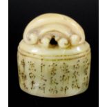 A Chinese hardstone oval seal, surmounted by carved scroll finial, 1.875ins (4.7cm) x 1.25ins (3.