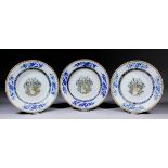 Three Chinese export armorial porcelain plates, the centres painted en grisaille and decorated in