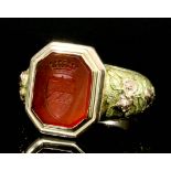 A gentlemen's rose and yellow gold coloured metal mounted carnelian set ring, the octagonal