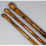 A Japanese bamboo walking cane carved with a snake, frogs and snail, 35.25ins (89.5cm) long, another