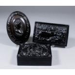 A 19th Century Bois Durci box, the lid press moulded with two doves on a nest, within a quatrefoil-