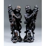 A pair of Chinese hardwood carved figures of Li-Ti-Guei with a three legged toad on his shoulder,