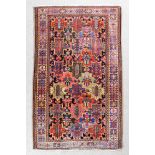 A Bakhtiari rug woven in colours with six vertical rows, each of stylized cross design filled with