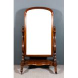 A Victorian mahogany framed rectangular cheval mirror, the moulded frame with arched top and inset