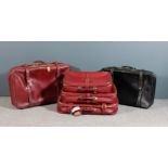 A set of four red leather suitcases retailed by Fortnum & Mason of Piccadilly, London, 22.5ins x