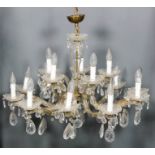 An Italian gilt metal and cut glass fifteen light electrolier, the central column with bulbous knops