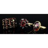 A late Victorian gold coloured metal mounted garnet set ring, the cabochon stone of approximately