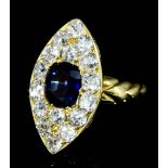 An early 20th Century 18ct gold mounted sapphire and diamond marquise pattern ring, the central