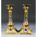 A pair of Royal Crown Derby bone china "Imari" candlesticks (model 1128), 10.5ins high (one with