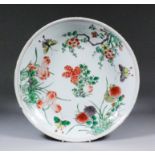 A Chinese "Famille Verte" porcelain saucer-shaped dish painted with flowering water lilies, prunus