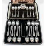 A set of twelve late Victorian silver teaspoons and matching sugar tongs, the handles with