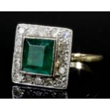 A modern 18ct white and yellow gold mounted emerald and diamond ring, the square cut emerald of