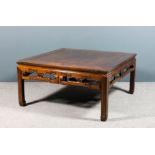 A Chinese blackwood square coffee table with plain flush panelled top, the fretted and carved aprons