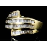 A modern 14k gold diamond set ring, the face channel set with sixty-six baguette cut diamonds each