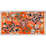 A Chinese rug woven in colours with two four clawed dragons and two exotic birds on an orange