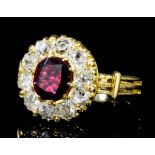 A modern gold coloured metal mounted ruby and diamond flowerhead ring, the central cushion cut
