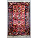 A good Bakhtiari rug woven in colours with a trellis design, with bold flowerhead ornaments at the