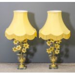 A pair of French gilt brass electric table lamps in the form of vases of flowers, on green and white