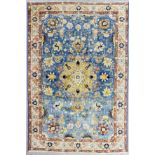 A Tabriz carpet woven in colours with a bold central medallion and bold leaf palmettes, on a sky