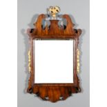 A mahogany and gilt framed rectangular wall mirror of "18th Century" design, the shaped cresting