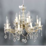 An Italian gilt metal and cut glass fifteen light electrolier, the central baluster shaped column