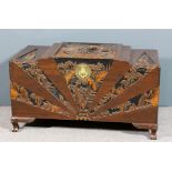 An early 20th Century Chinese camphor wood chest of "Art Deco" design, carved with a river landscape