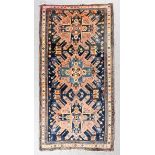 A Karabakh Chelaberd rug woven with three bold lozenge and star motifs and numerous birds and animal