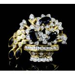 A modern 18ct gold mounted sapphire and white sapphire set floral basket pattern brooch set with six