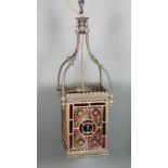 A late Victorian pressed and sheet brass framed and stained glass hall lantern, the four glass