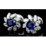 A pair of modern silvery coloured metal mounted sapphire and diamond flowerhead pattern earrings (