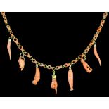 A Victorian gold coloured metal mounted coral necklace hung with seven small carved coral charms
