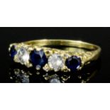 A gold coloured metal mounted sapphire and diamond five stone ring, the central stone of .25ct,