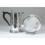 A George III silver circular waiter with moulded rim, on four ball pattern feet, 5.75ins diameter,