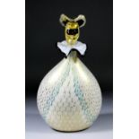 A Venetian glass ovoid decanter in the form of a carnival figure with masked face pattern stopper,