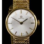 A modern lady's 9ct gold Omega wristwatch, the white dial with baton numerals, in plain 20mm