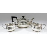 A George V silver rectangular three piece tea service with gadroon mounts and moulded bodies,