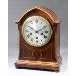 An early 20th Century German mahogany cased mantel clock, the 6ins diameter silvered dial with Roman