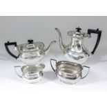 An Elizabeth II silver rectangular four piece tea and coffee service with gadroon mounts, ebonised