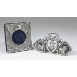 A late Victorian silver triple heart pattern photograph frame surmounted by shield and scroll