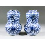 A pair of Chinese blue and white porcelain double-gourd vases painted with stylised flowering