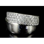 A modern 14k white gold and diamond set ring, the face pave set with fifty nine small brilliant